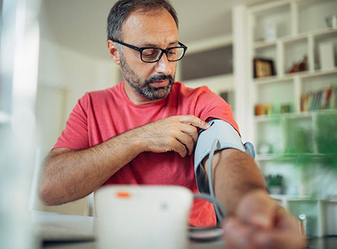 A man using a blood pressure monitor
