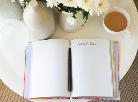 A gratitude journal lies open on the table.