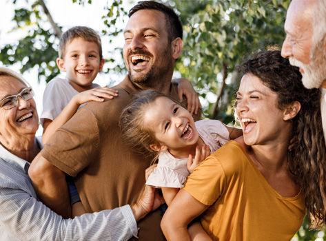 A large nucleur family hugs and laughs.