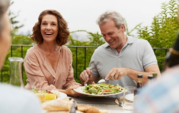 middle aged couple eating dinner together