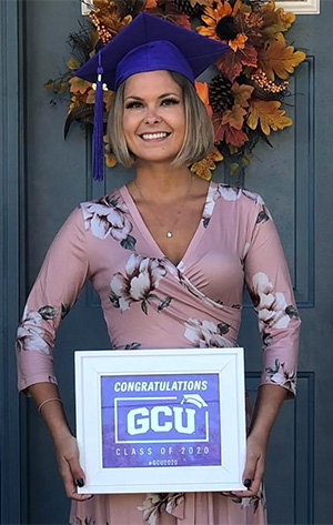 Erika posing with her GCU diploma