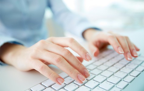 Person typing on computer