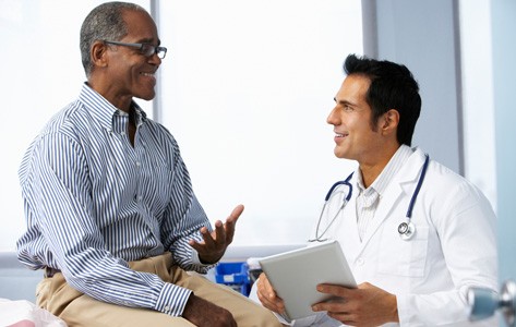 Vascular specialist talks to patient