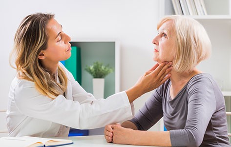Speech therapist checks patient's vocal cords
