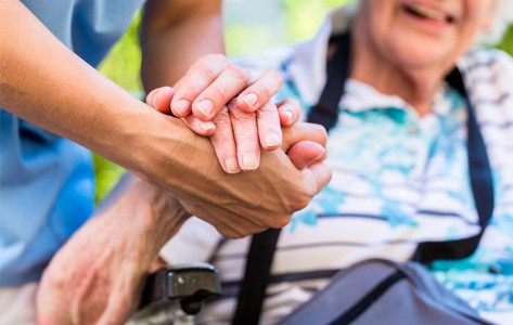 Holding hands with palliative care patient