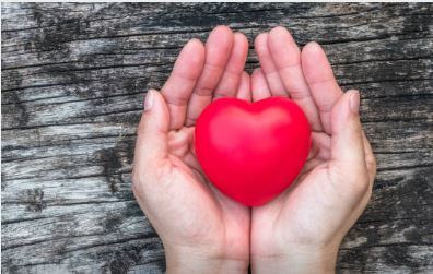 A porcelain heart cupped in two hands.