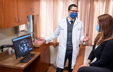 Dr. Pepen discussing general surgical procedure with patient