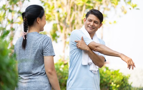 Woman playing tennis middle-aged couple stretching