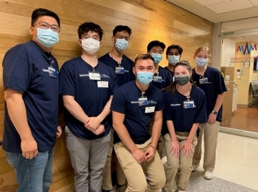 A group of volunteers gathers in the hallway of Morristown Medical Center.