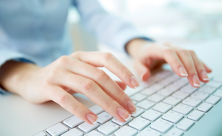 Hands of person typing on keyboard